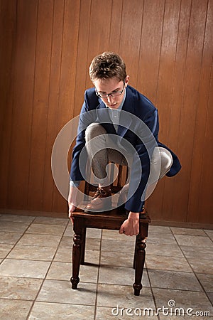 Man Stands On Chair Stock Photo