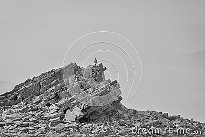 Man stands on a natural pyramid from plane stones Stock Photo
