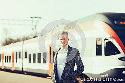 Man stands near a modern train Stock Photo