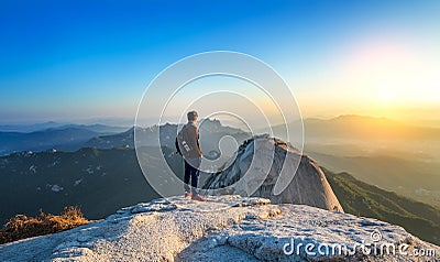 Man stands on the peak of stone in Bukhansan national park. Stock Photo