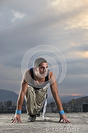 Man on the start position ready to run Stock Photo