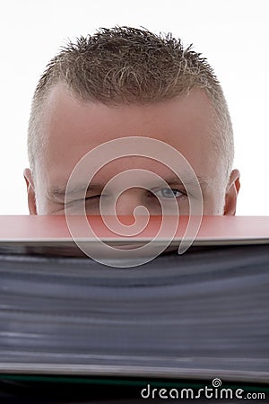 Man stashed behind folders Stock Photo