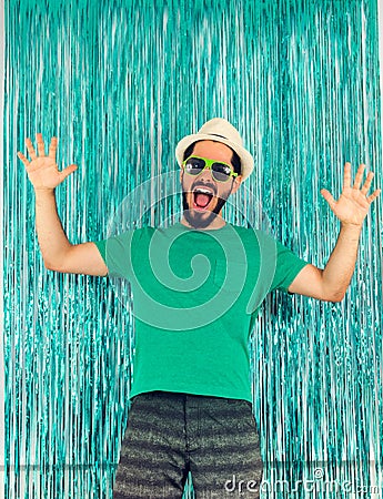 Man is in a state of euphoria, screaming and celebrating. Carnival in Brazil, birthday party, eve of the end of the year. Green c Stock Photo