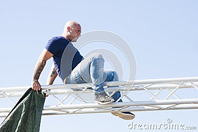 Man on steel structure no protection for safety Editorial Stock Photo