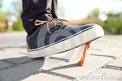 Man stepping in chewing gum on sidewalk. Concept of stickiness Stock Photo