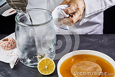 Man sterilising a glass jar with boiling water Stock Photo