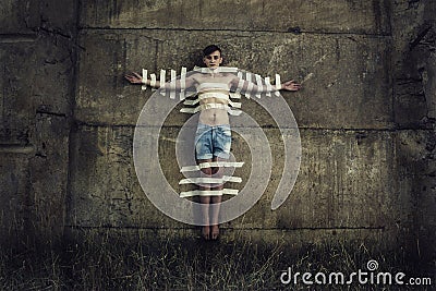 Man sticked to the wall with adhesive tape Stock Photo