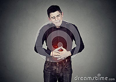 Man with stomach pain indigestion abdomen colored in red Stock Photo