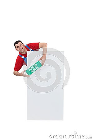 Man stood with wet paint sign Stock Photo