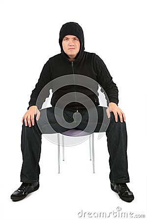 Man is strained, sits on a chair Stock Photo