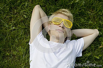 Man strange sunglasses lying on grass Stock Photo