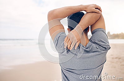 Man, stretching and arms on beach, exercise and warm up for fitness, ready and workout by ocean. Male person, back and Stock Photo
