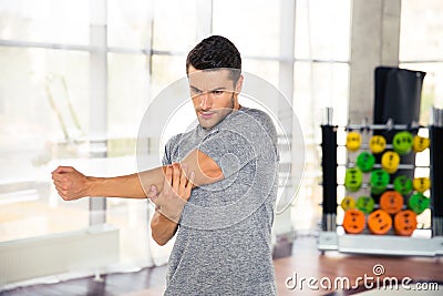 Man stretching hands at gym Stock Photo