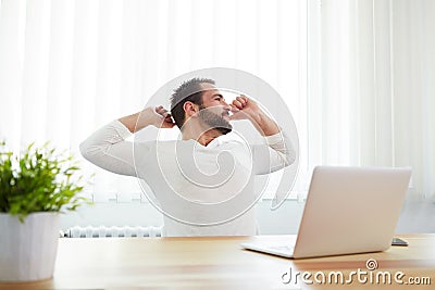 Man stretching his back at desk Stock Photo