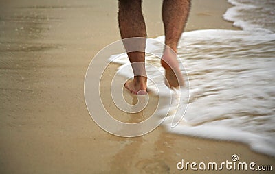 Man strolling through the surf Stock Photo