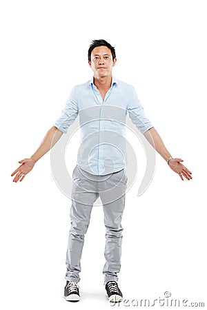 Man, studio portrait and arms outstretch with fashion, sneakers and edgy jeans by white background. Isolated Asian model Stock Photo