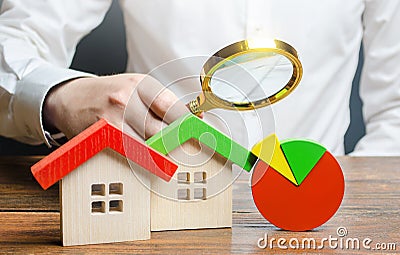 Man is studying the structure of housing costs with a magnifying glass. Revision of utility bills and tariffs. Efficient water Stock Photo