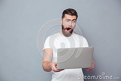 Man with stupid mug using laptop Stock Photo