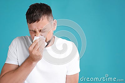 Man suffering allergy on blue background. Space for text Stock Photo