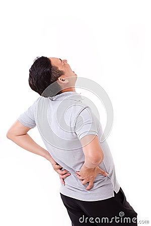 Man suffering from back pain, hand holding back Stock Photo