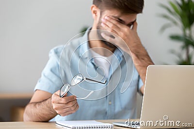 Man suffering from dry eyes syndrome after long computer work Stock Photo