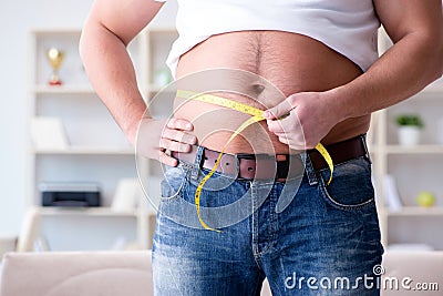 The man suffering from extra weight in diet concept Stock Photo