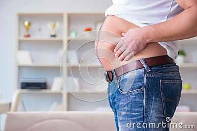 The man suffering from extra weight in diet concept Stock Photo