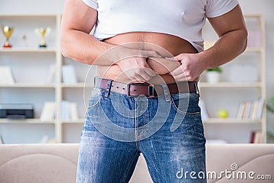 The man suffering from extra weight in diet concept Stock Photo