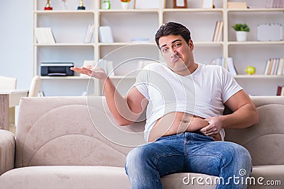 The man suffering from extra weight in diet concept Stock Photo