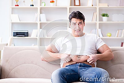 The man suffering from extra weight in diet concept Stock Photo