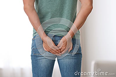 Man suffering from hemorrhoid at home Stock Photo