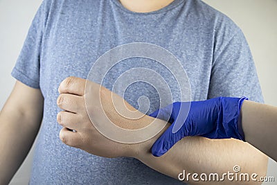 A man suffers from elbow pain. Damaged elbow joint, bone fracture, or sprain. Hand injury and flexion pain concept Stock Photo