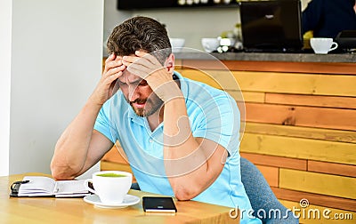 Man suffers headache. Deadline coming search ideas need inspiration. Man disappointed desperate face sit cafe with mug Stock Photo