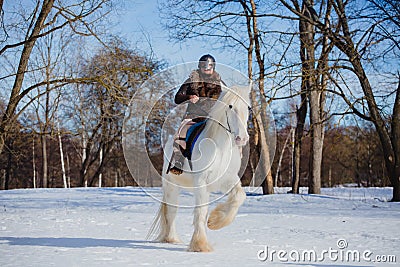 Man in suit of ancient warrior riding big white horse Stock Photo