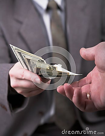 Man in suit giving dollars Stock Photo