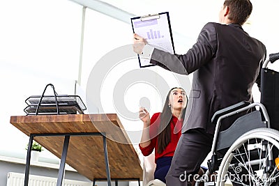 Man in suit got up from wheelchair, girl in shock Stock Photo