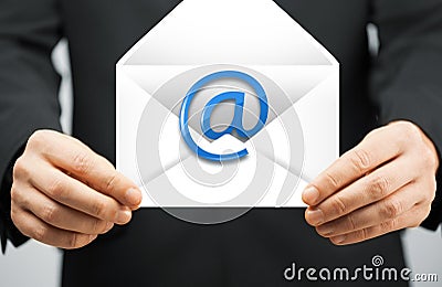 Man in suit holding envelope with email sign Stock Photo