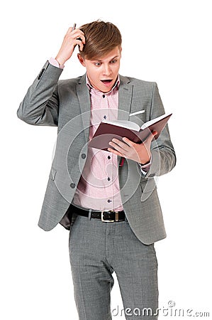 Man in suit looking very shocked with notepad Stock Photo