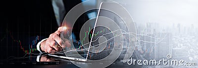 A man in a suit points to a graph on a rapidly expanding stock chart on a computer screen with his right hand. Background of a Stock Photo