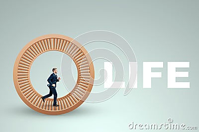A man in a suit runs in a hamster wheel. The concept of liberation from slavery, life, business, manipulation, control Stock Photo