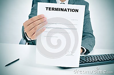 Man in suit showing a figured signed termination document Stock Photo
