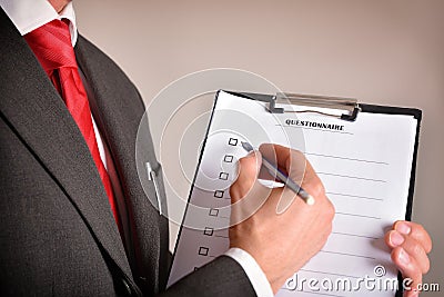 Man in suit showing a questionnaire side view Stock Photo