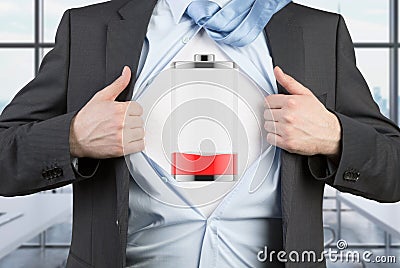 A man in a suit is tearing the blue shirt. Low level of power on the chest. Stock Photo