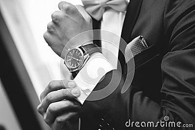 Man with suit and watch on hand Stock Photo