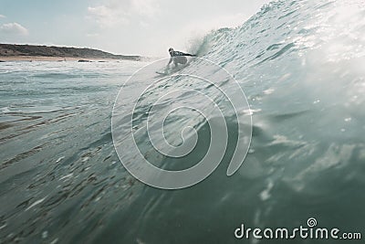 Man surfer on the blue sea with large waves Stock Photo