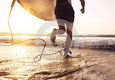 Man surfer run in ocean with surfboard. Active vacation, health Stock Photo