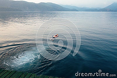 Man swimming in the erly morning. Editorial Stock Photo