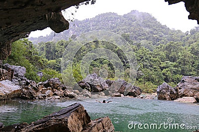 Man swimming in Nuoc Mooc lake, romantic and peaceful scenery Stock Photo