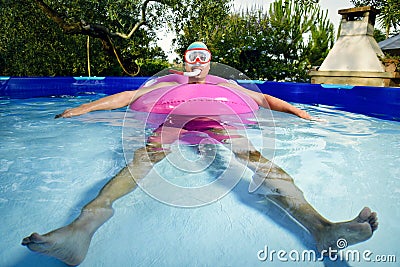 Man swimming in a portable swimming pool Stock Photo