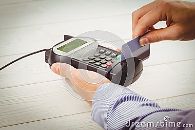 Man swiping his credit card Stock Photo